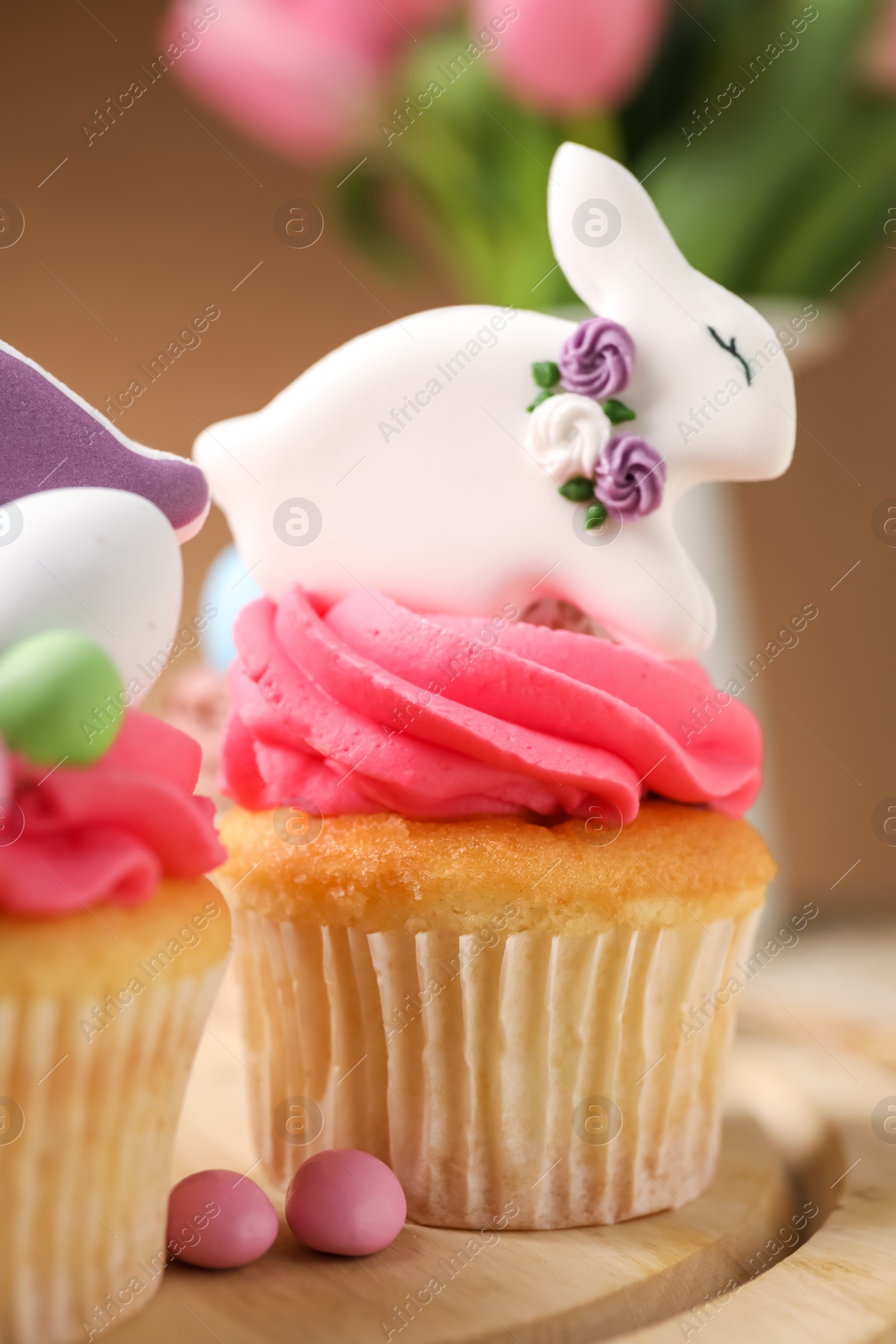 Photo of Tasty cupcakes with Easter decor on table, closeup