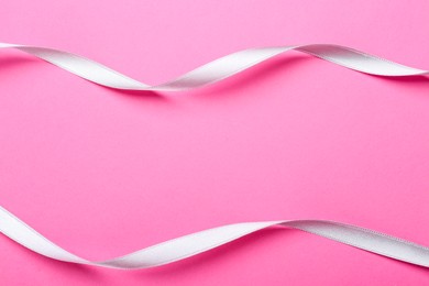 Photo of Beautiful ribbons on pink background, flat lay. Space for text