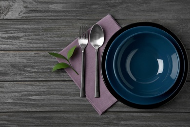 Beautiful table setting on dark wooden background, flat lay