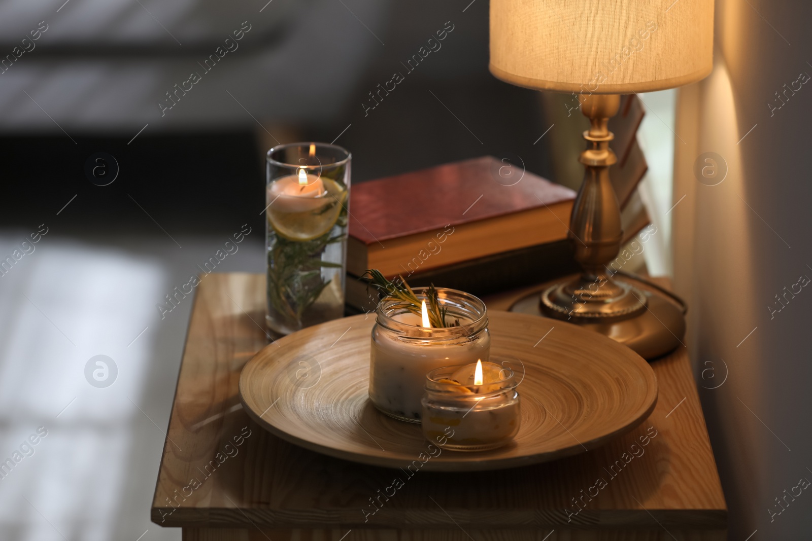 Photo of Natural homemade mosquito repellent candles on wooden table in room