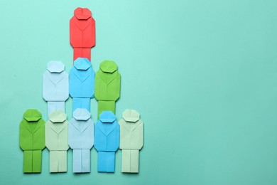 Photo of Many colorful paper figures on light blue background, flat lay with space for text. Recruiter searching employee