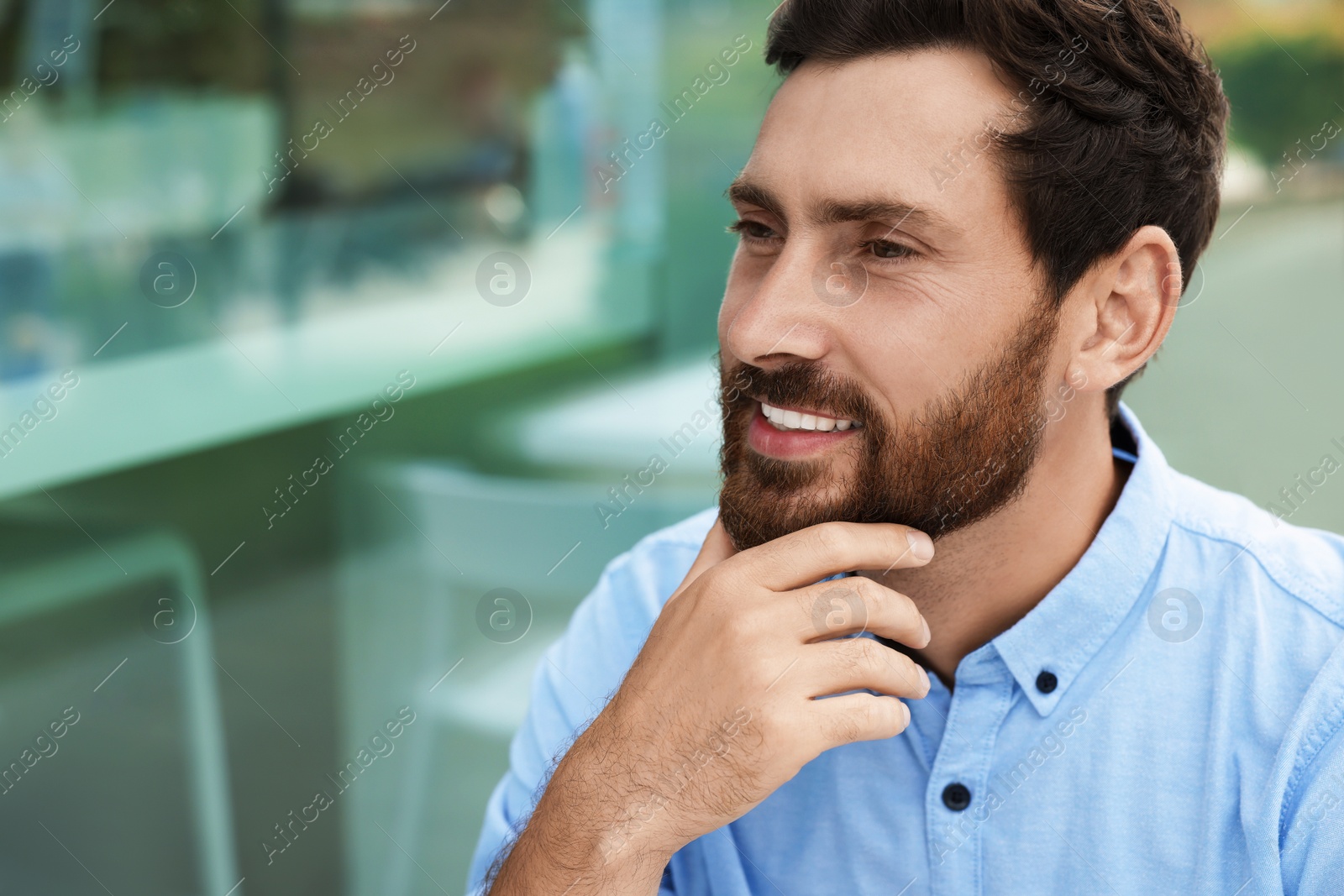 Photo of Portrait of handsome bearded man outdoors, space for text