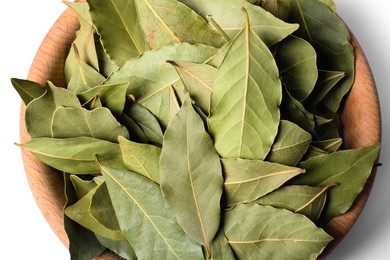 Aromatic bay leaves in wooden bowl on white background, top view