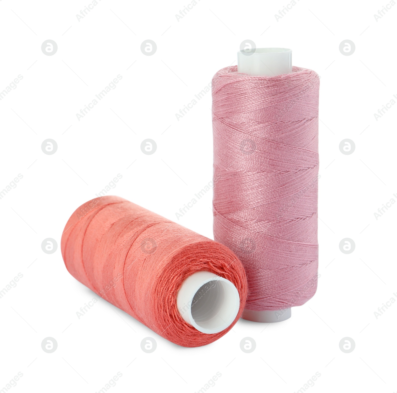 Photo of Different colorful sewing threads on white background