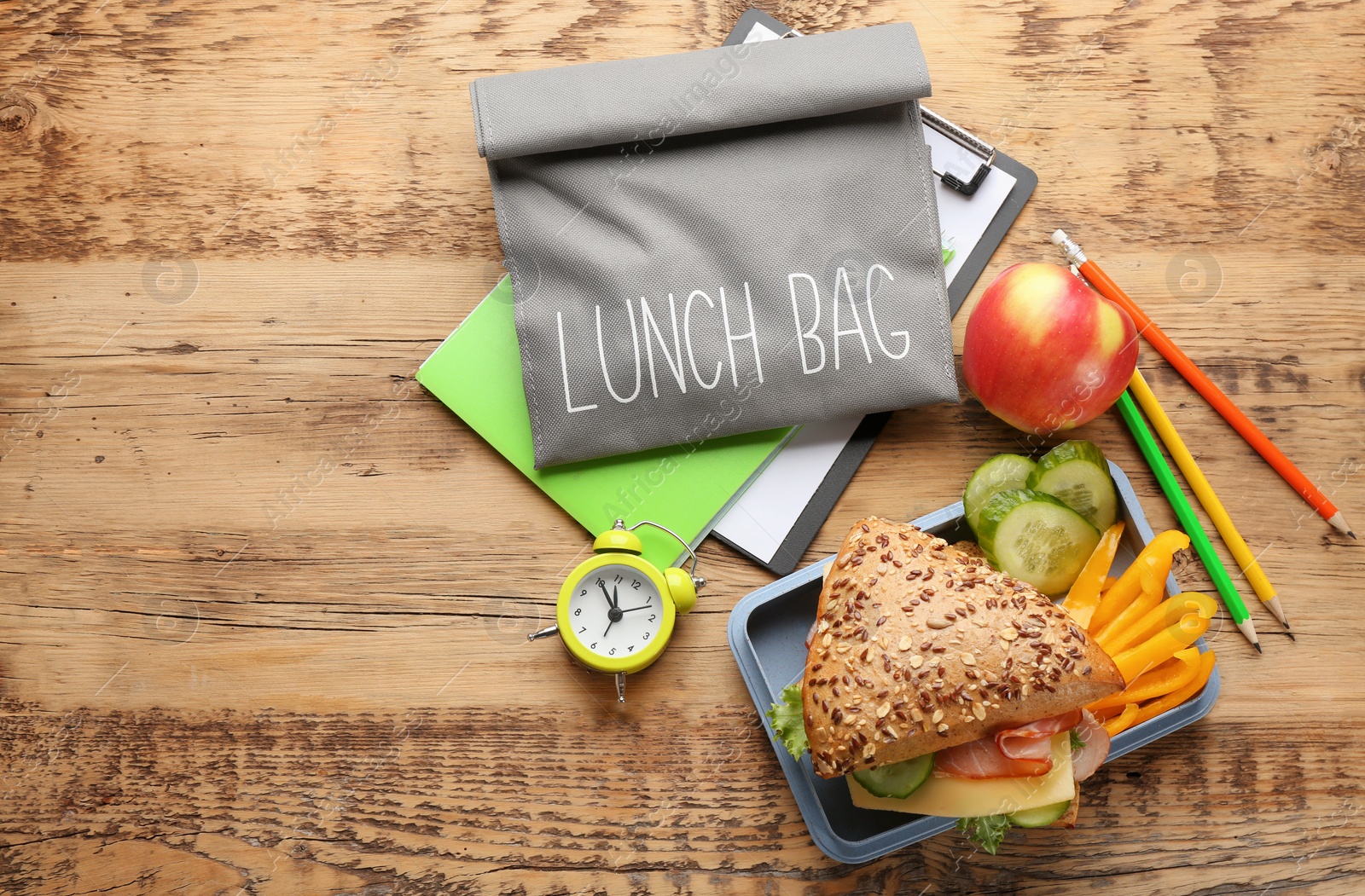 Photo of Composition with lunch box and food on wooden background