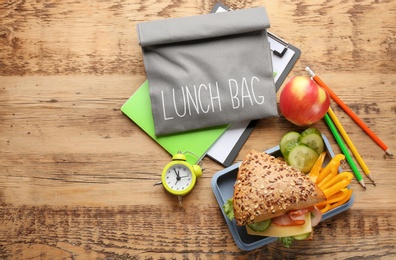 Photo of Composition with lunch box and food on wooden background