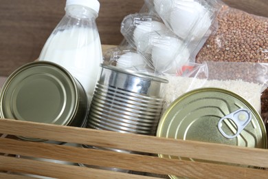 Photo of Donation box with different food products, closeup