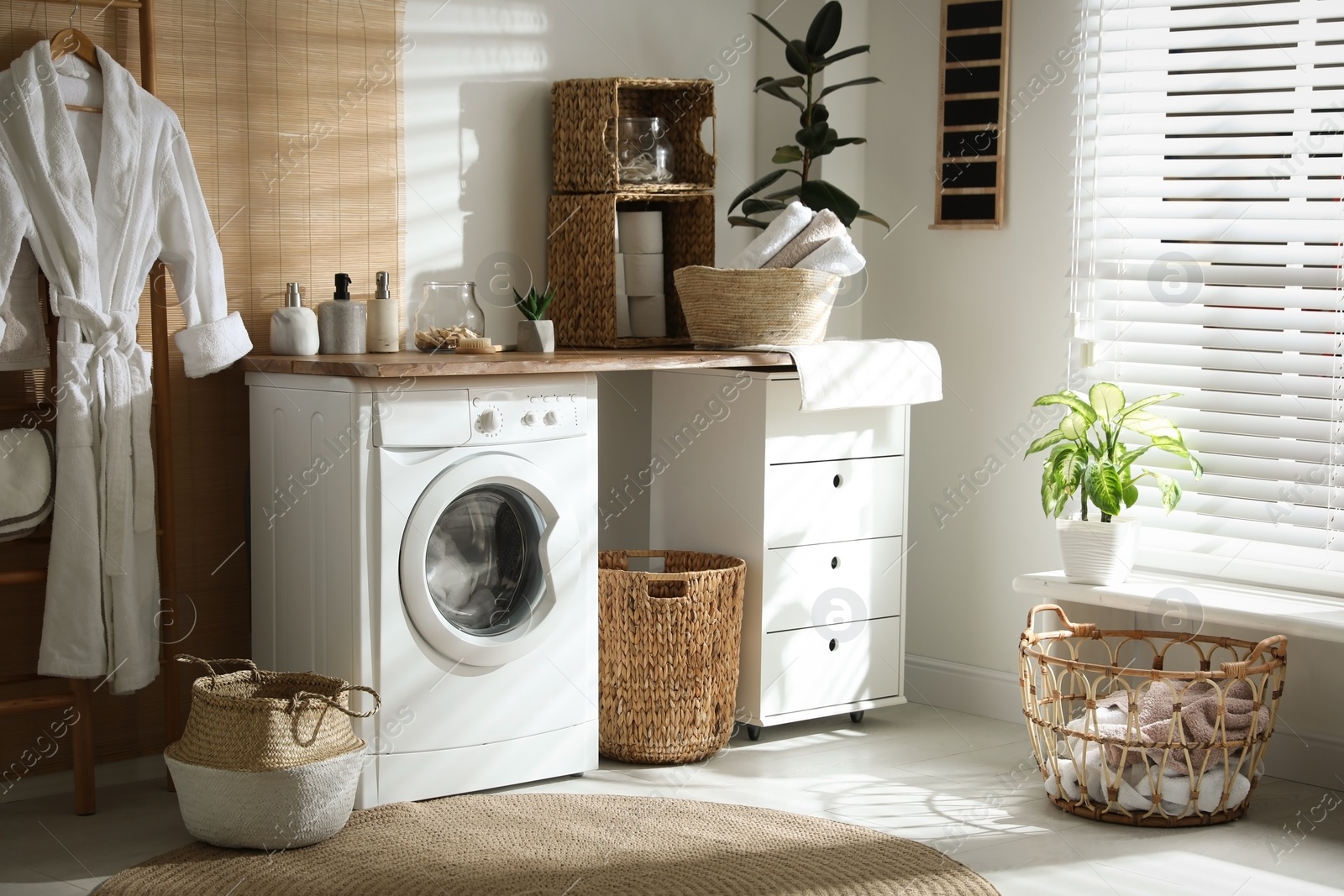 Photo of Stylish bathroom interior with modern washing machine