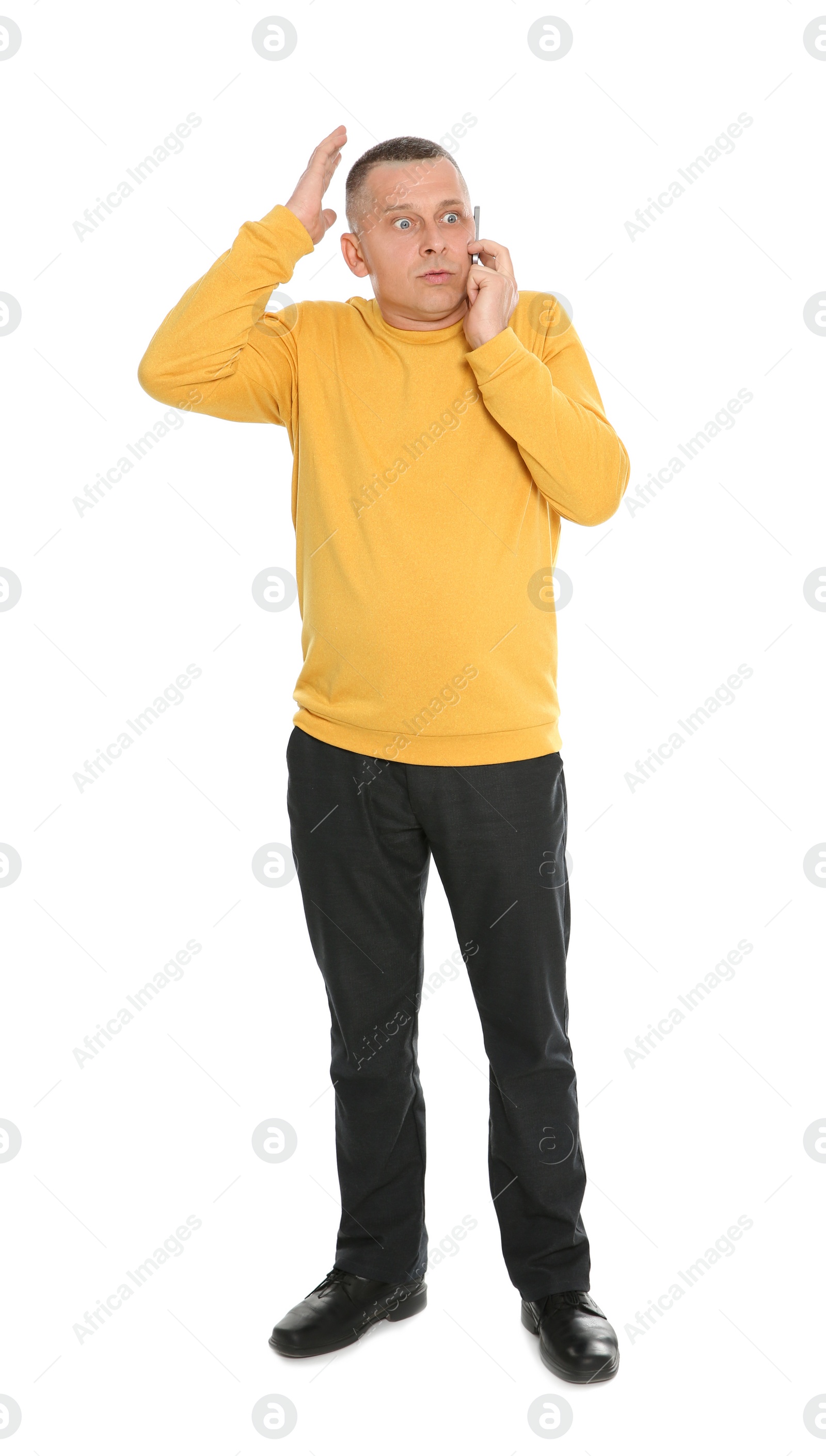 Photo of Full length portrait of emotional mature man talking on phone against white background