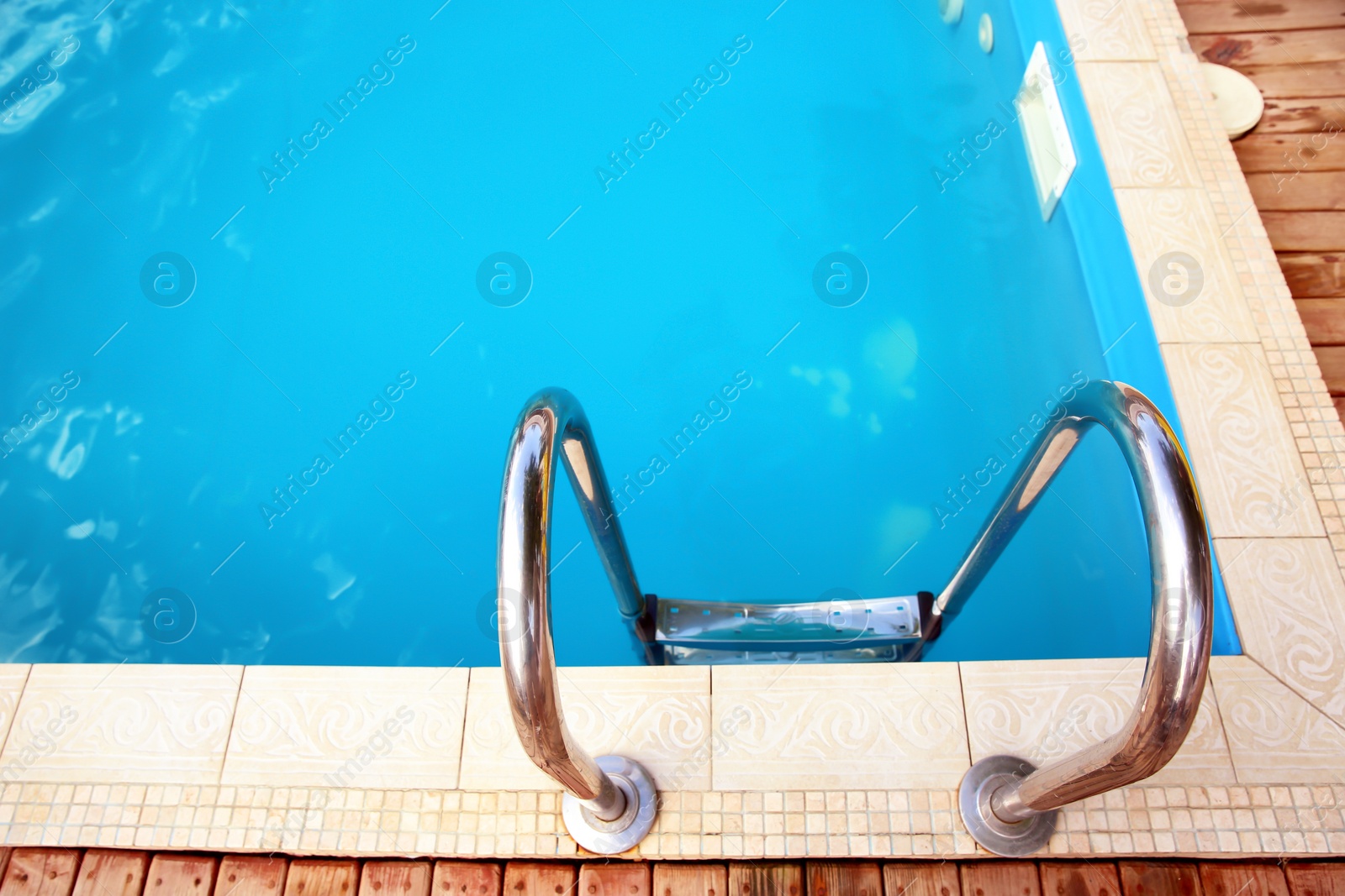 Photo of Modern swimming pool with step ladder at resort