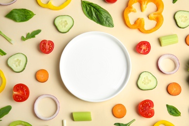 Photo of Flat lay composition with fresh salad ingredients on beige background, space for text