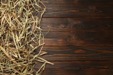 Photo of Dried hay on wooden background, flat lay. Space for text