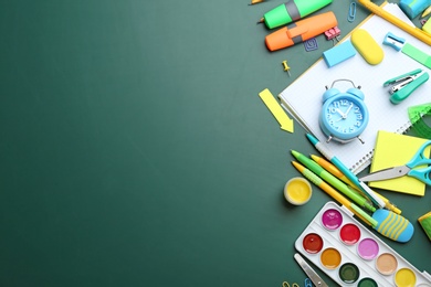 Photo of Different bright school stationery on green background, flat lay. Space for text