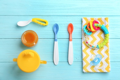 Flat lay composition with baby food and accessories on wooden background