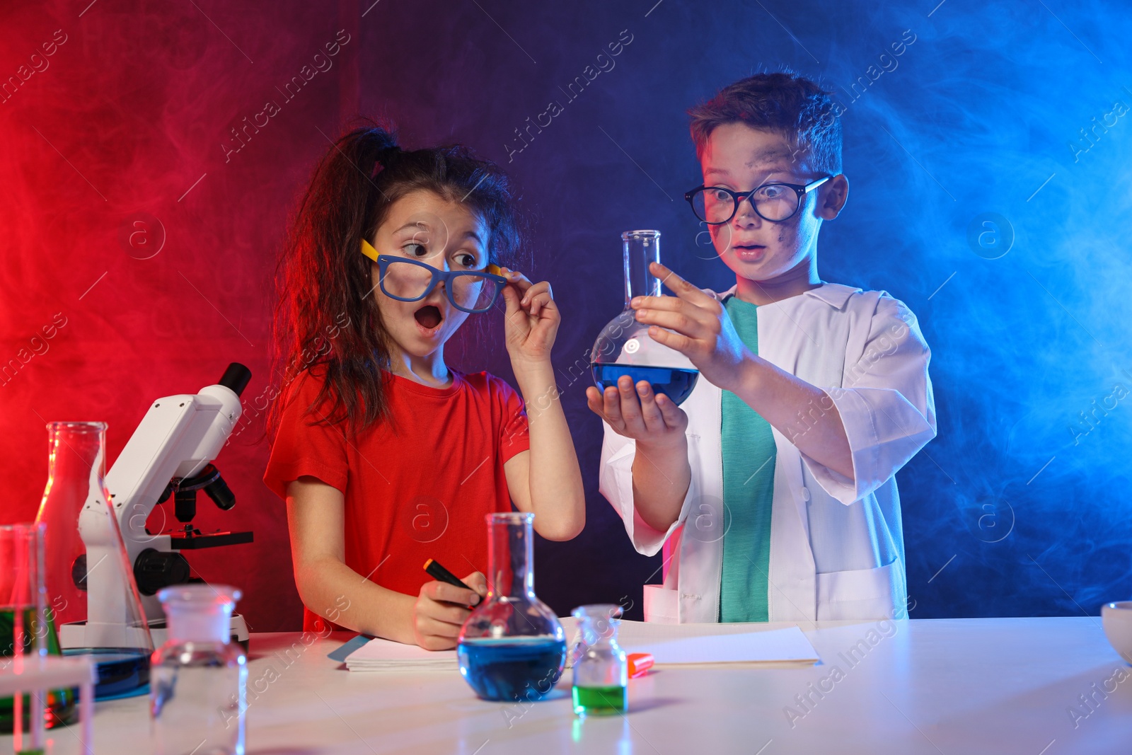 Photo of Children doing chemical research in laboratory. Dangerous experiment