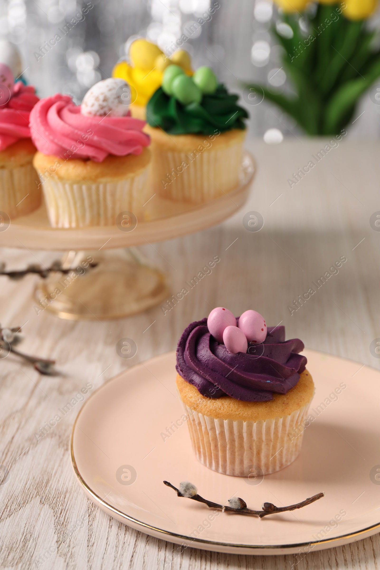 Photo of Tasty Easter cupcakes on wooden table, selective focus