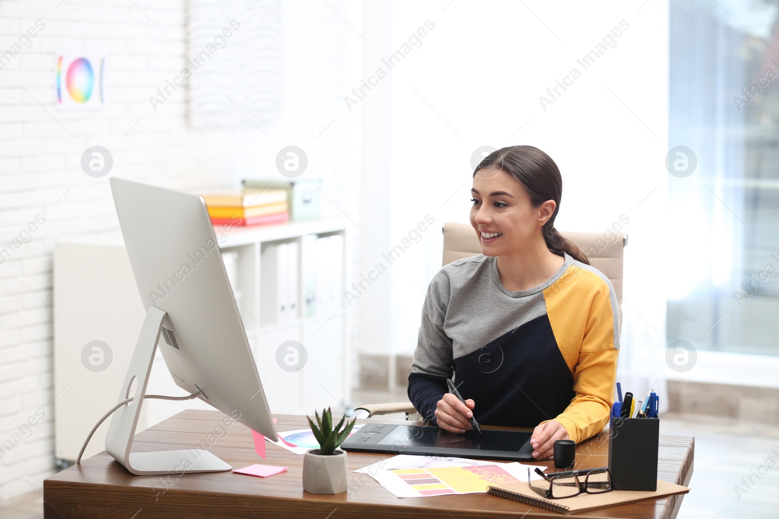 Photo of Female designer working at desk in office