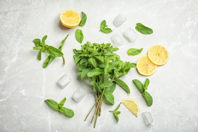 Photo of Flat lay composition with mint, citrus fruit and ice cubes on light background