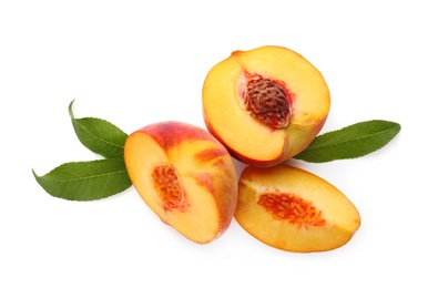 Photo of Cut fresh ripe peaches with leaves on white background, top view
