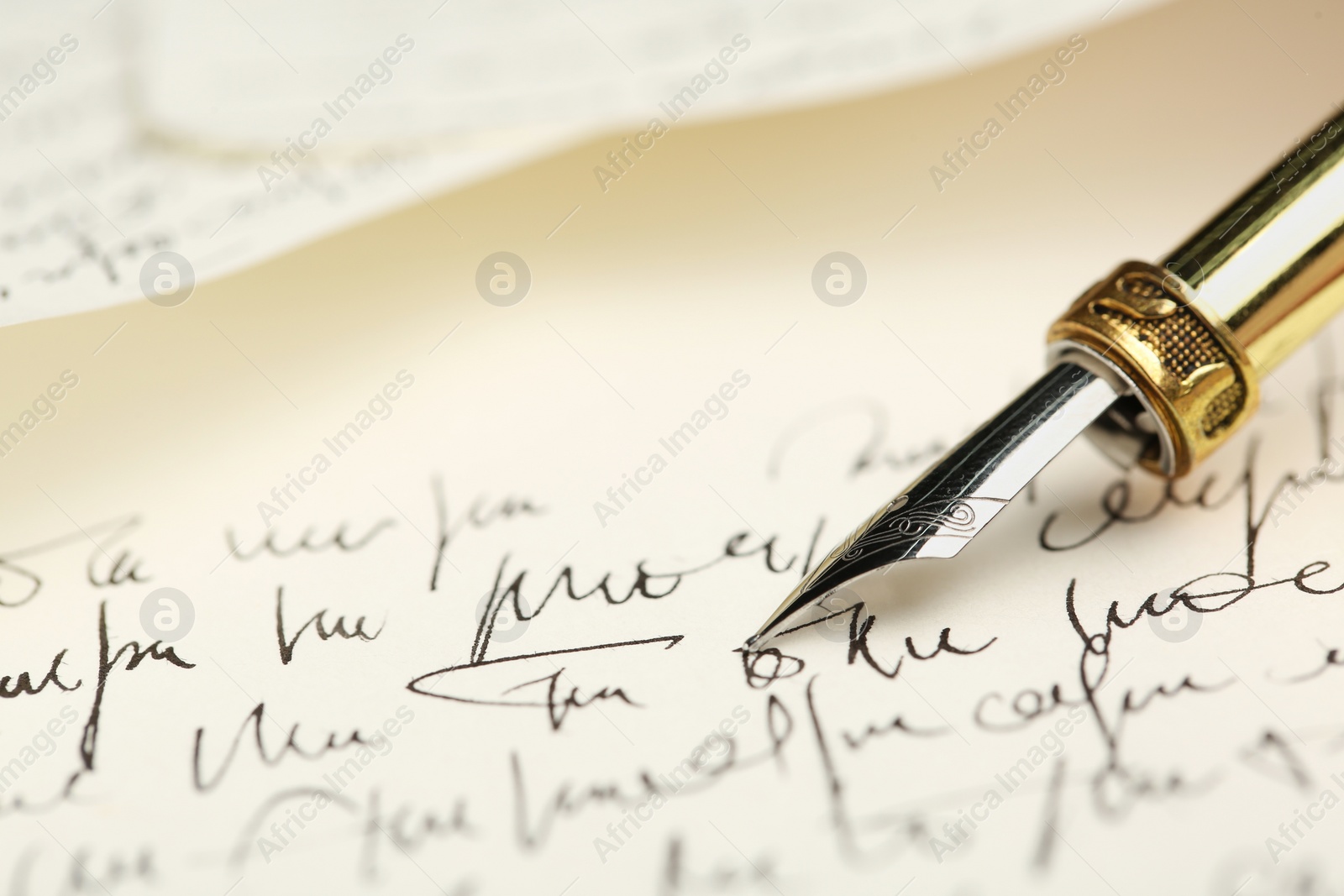 Photo of One fountain pen on handwritten letter, closeup