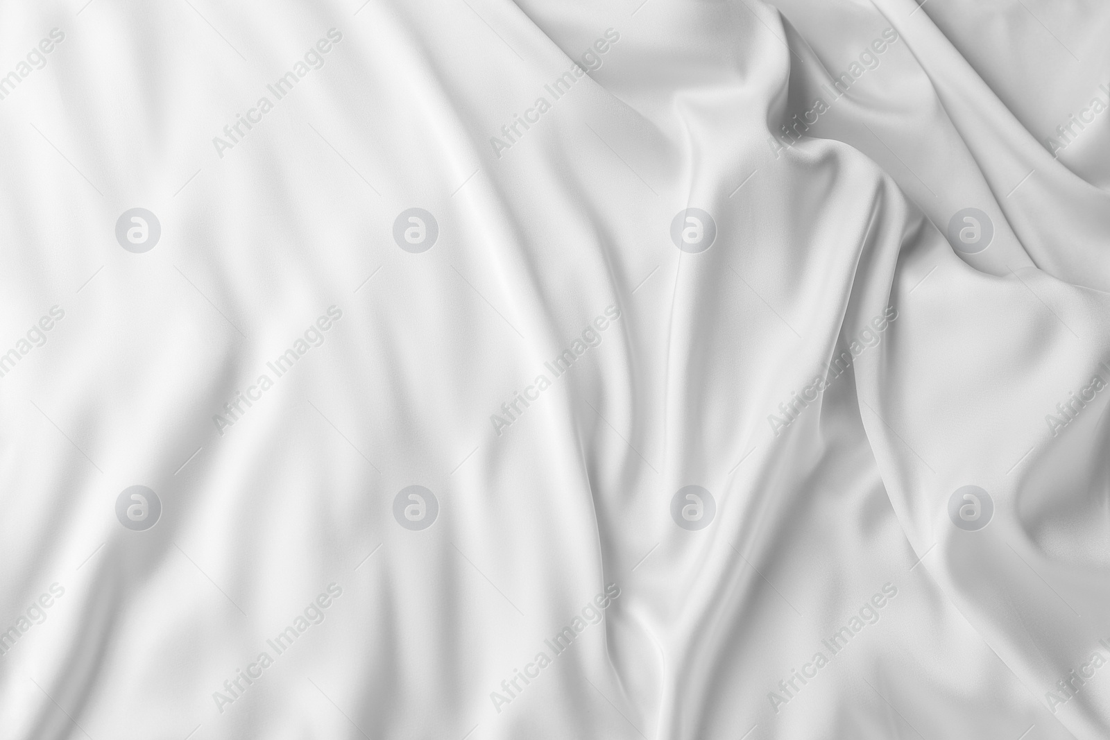 Photo of Texture of white silk ripple fabric as background, top view