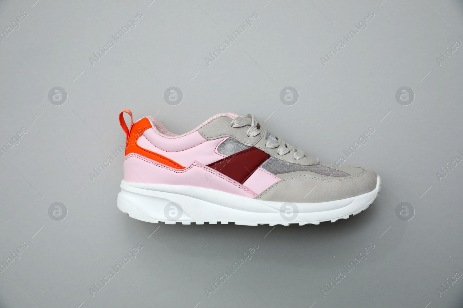 Photo of Stylish women's sneaker on light grey background, top view