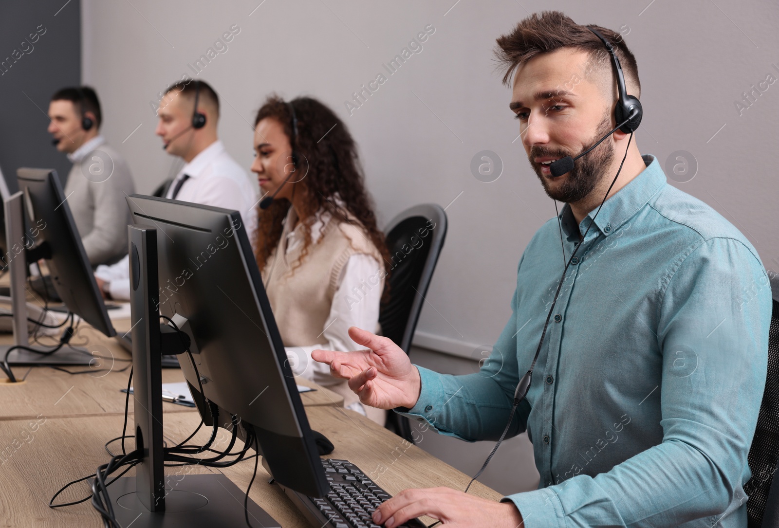 Photo of Call center operators working in modern office