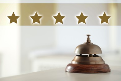 Image of Five Star Luxury Hotel. Service bell on table indoors 