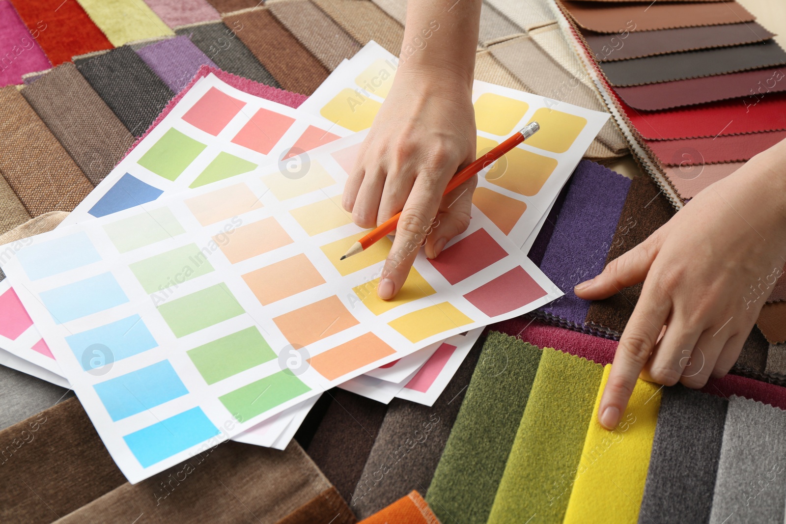 Photo of Woman choosing among colorful fabric samples, closeup