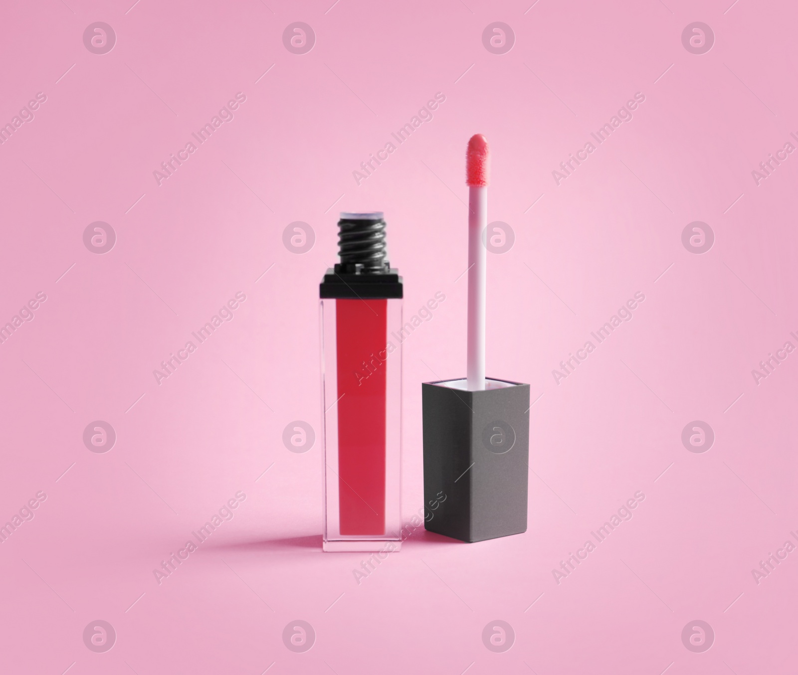 Photo of Liquid lipstick tube with applicator on color background