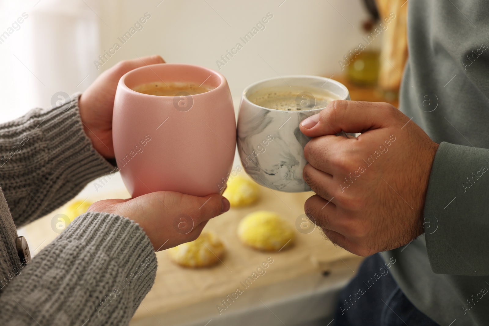 Photo of Couple drinking coffee at home, closeup view