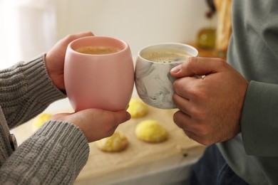 Photo of Couple drinking coffee at home, closeup view