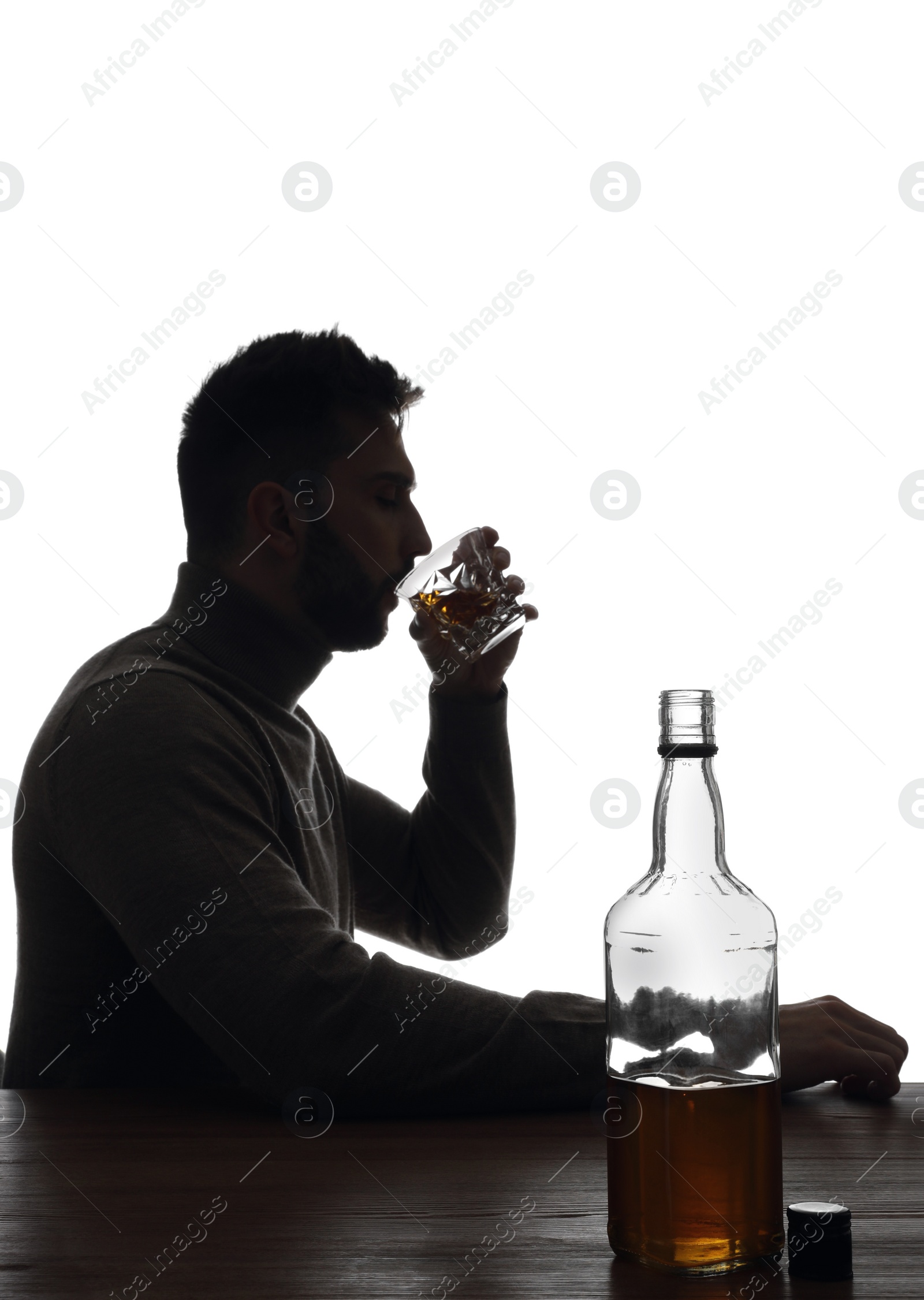Photo of Silhouette of addicted man drinking alcohol on white background