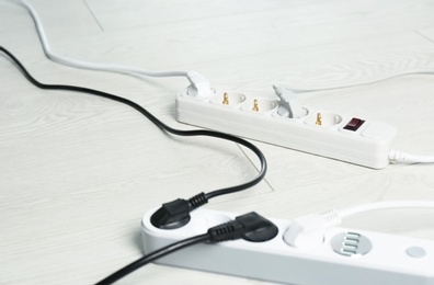 Extension cords on floor, space for text. Electrician's professional equipment