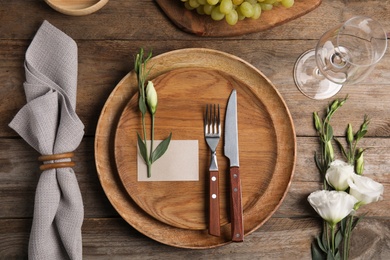 Photo of Elegant festive table setting on wooden background, flat lay