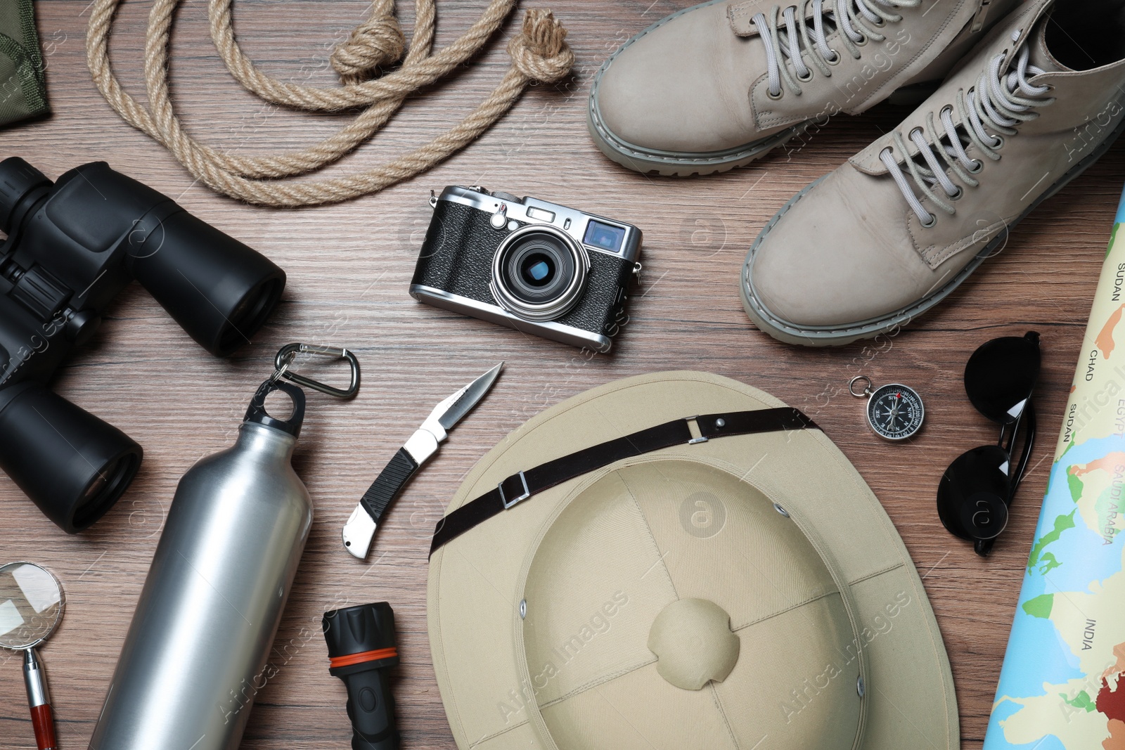 Photo of Flat lay composition with different safari accessories on wooden background