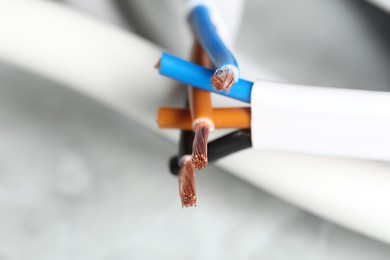 Photo of Colorful electrical wires on gray background, closeup