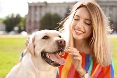 Cute yellow labrador retriever with owner outdoors