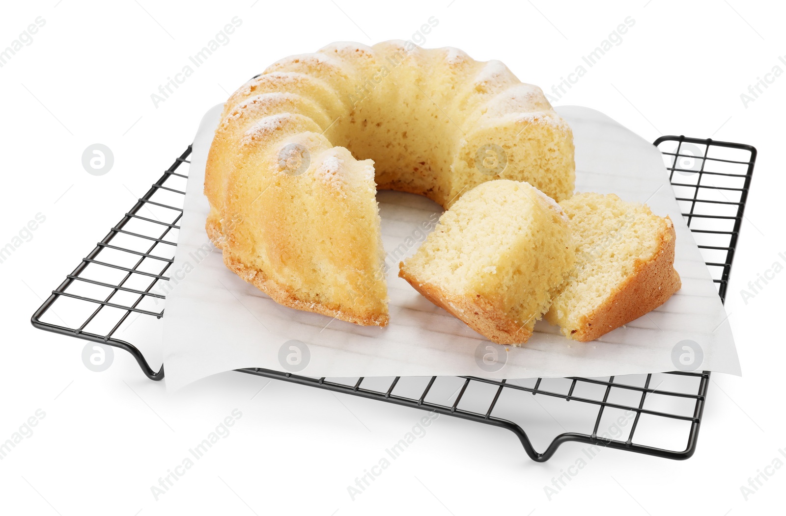 Photo of Cooling rack with freshly baked sponge cake isolated on white