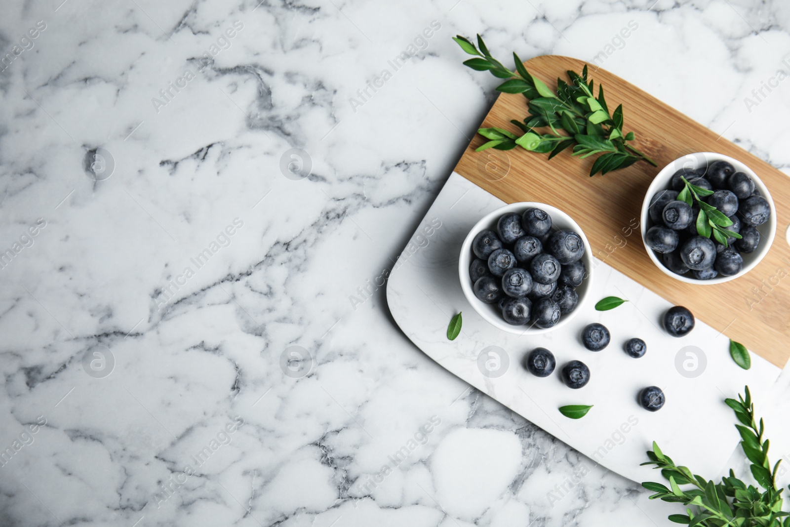 Photo of Composition with blueberries and space for text on marble table, flat lay