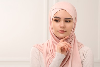 Photo of Beautiful Muslim woman wearing beige hijab indoors
