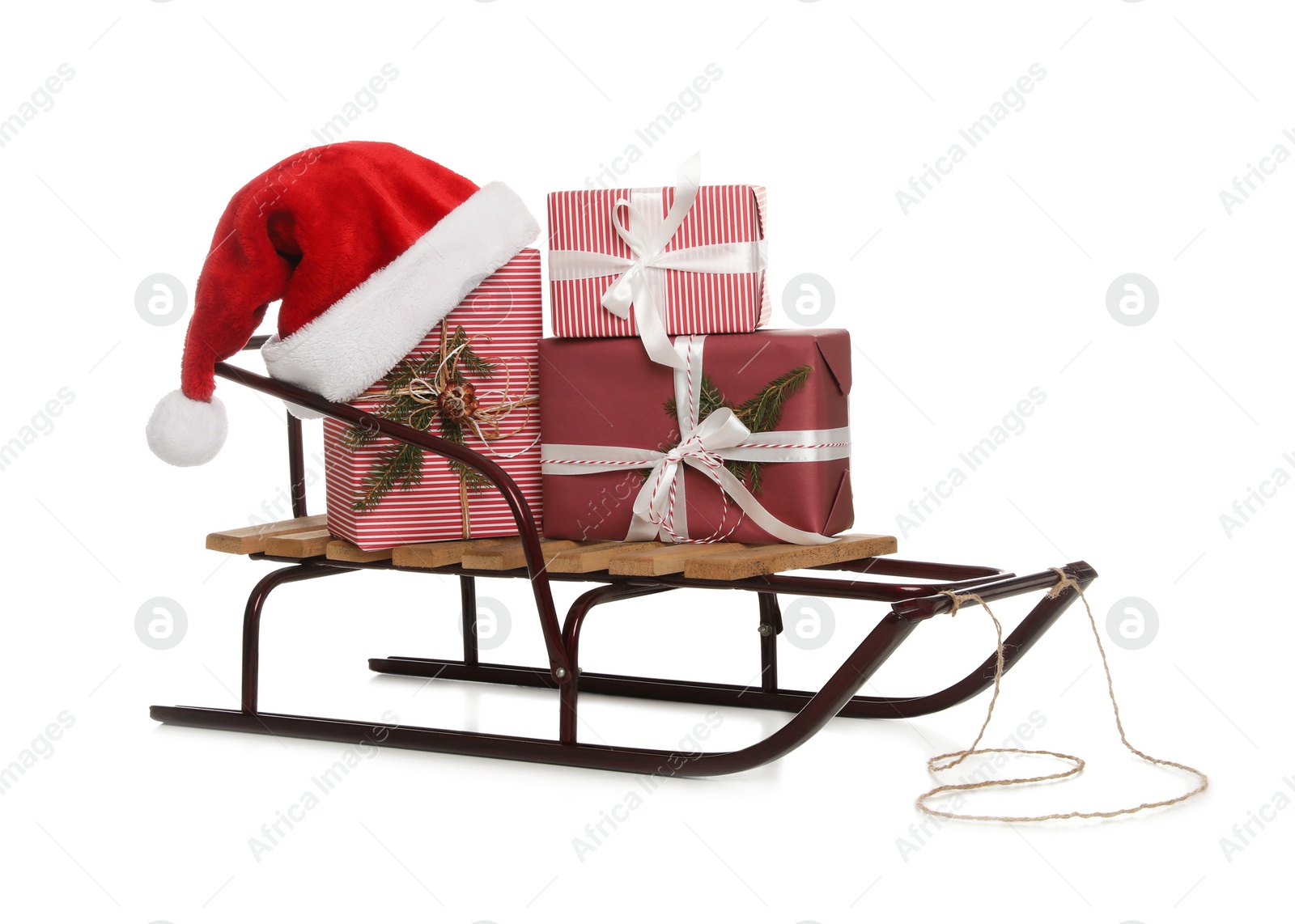 Photo of Sleigh with Christmas gifts and Santa hat isolated on white