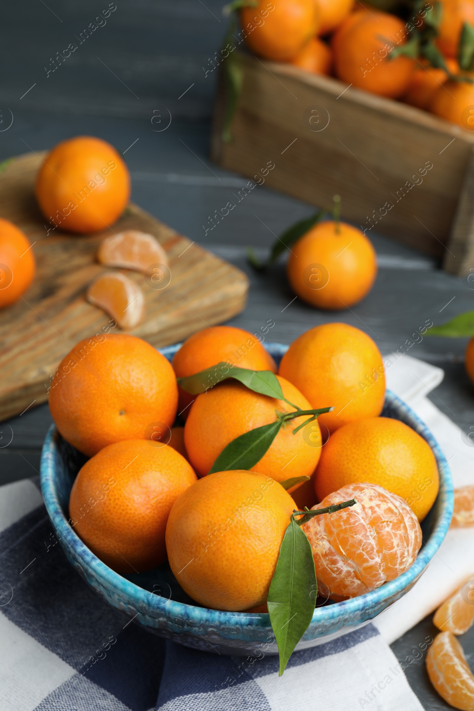 Photo of Fresh ripe tangerines in bowl on table