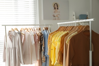 Photo of Collection of stylish women's clothes in modern boutique