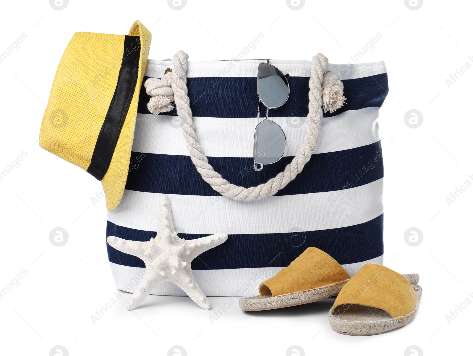 Photo of Stylish bag with beach accessories isolated on white