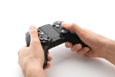 Photo of Young woman holding video game controller on white background, closeup