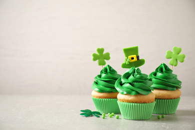 Delicious decorated cupcakes on light table, space for text. St. Patrick's Day celebration