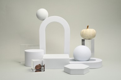 Autumn presentation for product. Geometric figures, pumpkins and acorn on light grey background