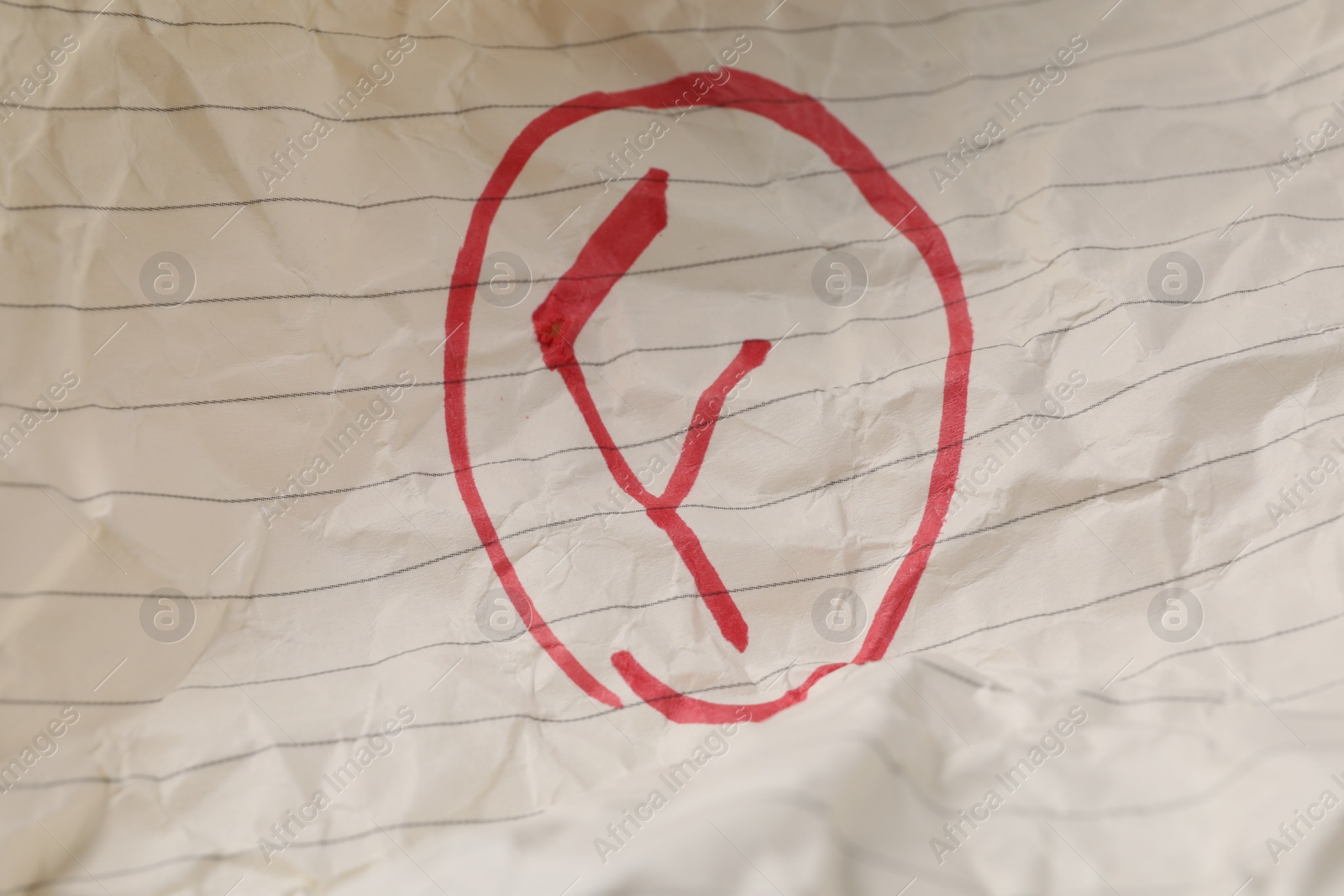 Photo of School grade. Red letter F on notebook paper, top view