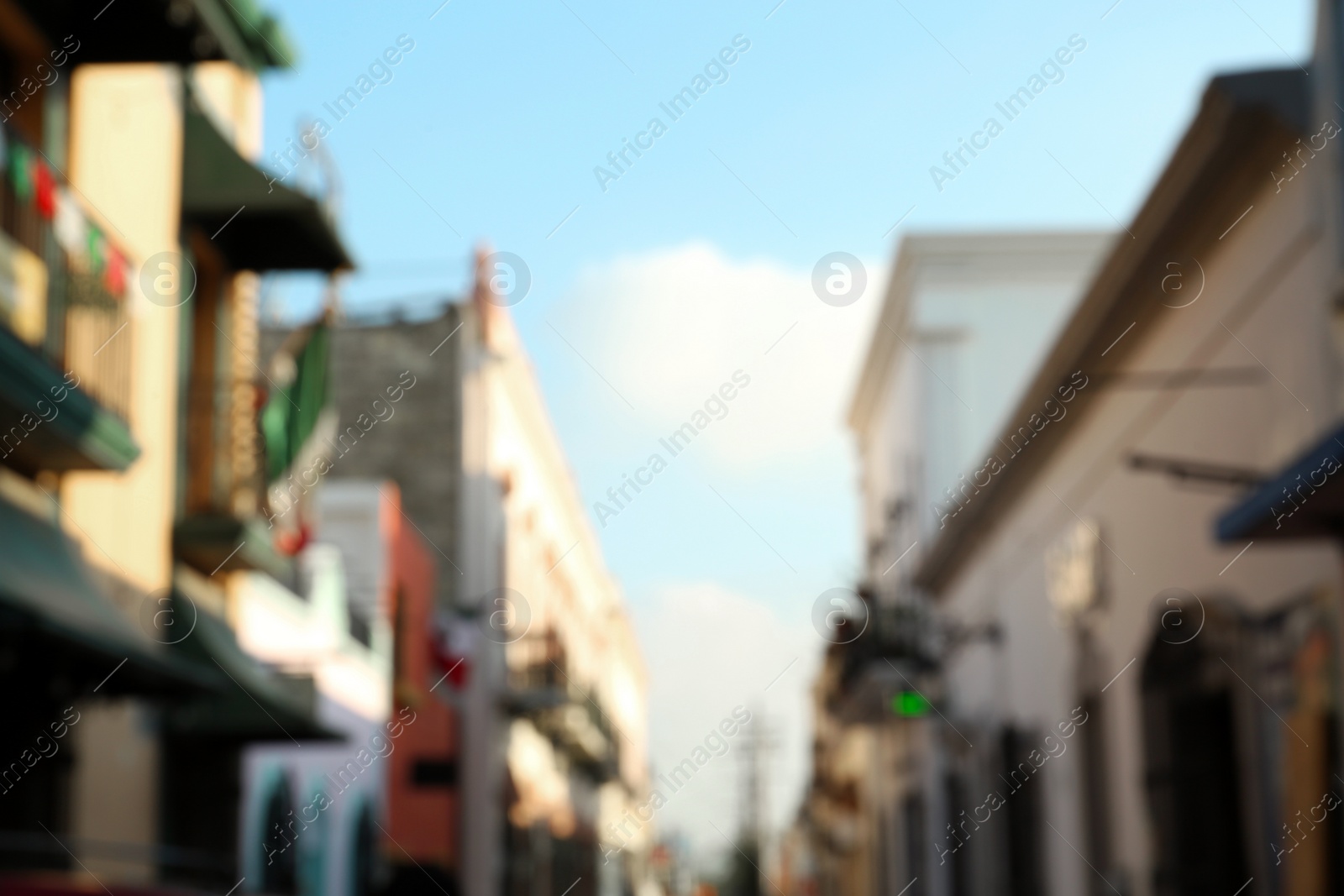 Photo of Blurred view of city street with old buildings